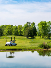 Golf Cart Reflecting In Large Water Hazard