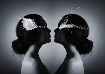 Two silhouettes of a woman's head opposite each other in a kiss pose. The concept of self-determination of human personality, women.