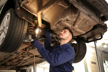 Canvas Print - Technician checking modern car at automobile repair shop