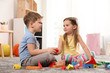 © New Africa - Little children playing with colorful blocks indoors