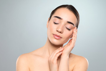 Poster - Portrait of young woman with beautiful face against color background