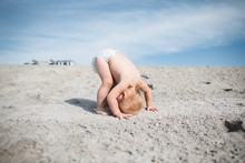 Toddler In Diaper Trying Headstand On Sand In Avalon New Jersey