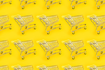 Shopping trolley on a yellow background. Modern trendy design for any purposes. Seamless geometric pattern. Online shopping