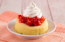 A Single Serve Strawberry Shortcakes With Strawberry Sauce And Whipped Cream