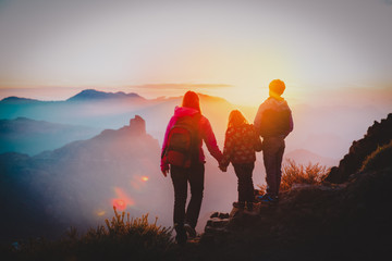 mother with kids travel in sunset mountains