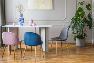 Pastel pink, blue and grey decorations in dining room