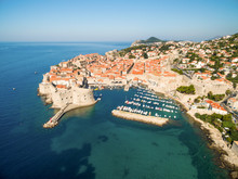 Aerial View Of Old City Of Dubrovnik (Croatia) With Old Port In Front. Dubrovnik Is Popular Tourist Attraction On Adriatic.