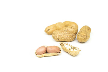 Close up roasted nuts with nutshells isolated on white background.