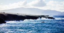Ocean Waves Crashing On Jagged Cliffs.