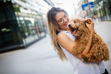 Wall Mural - Happy woman with her dog smiling and palying outdoor