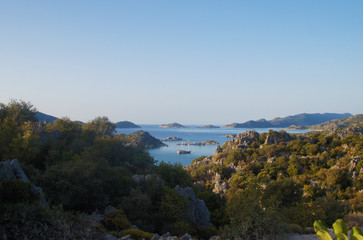 Beautiful summer seascape. Mountain coast of the blue sea. Rocks and forest near the ocean coast.