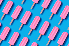 Pattern Made Of Bright Pink Strawberry Ice Cream On Blue Pastel Background.