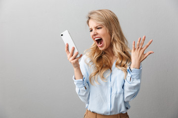 Sticker - Photo of angry puzzled businesswoman with long curly hair worrying and screaming while calling on smartphone