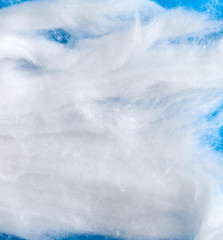 Poster - white wool with torn edges on a blue background