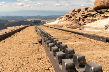 Cog railway 1, showing a close up of a two bar Abt rack and two running rail going up a mountain side