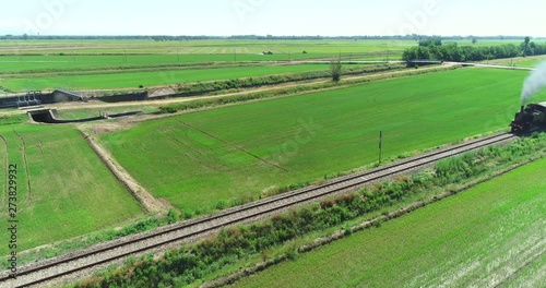 Fotomural Old steam train running on the tracks in the countryside