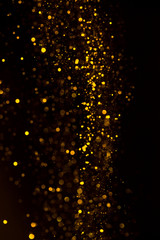 Wall Mural - Glitter dust gold particles dark abstract background