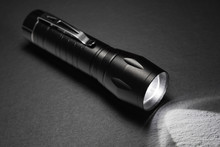 Black Flashlight On The Stone Surface. Tools For Work, Search And Tourism ..