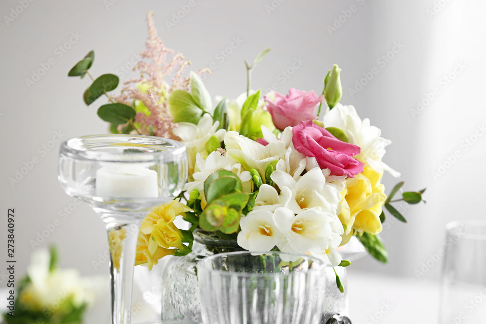 Beautiful bouquet with fresh freesia flowers on table, closeup