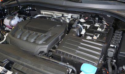 Car engine compartment is opened. View of clean engine compartment. Close up of car engine.