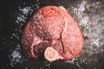 Wall Mural - Raw fresh meat with salt on the rustic background. Selective focus. Shallow depth of field. 