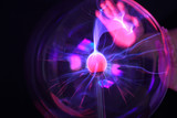 Fototapeta  - Closeup of plazma ball / globe and hands touching it