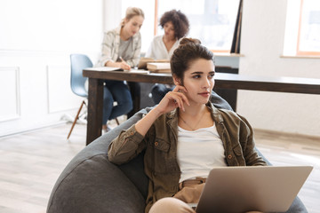 Poster - Lovely young woman using laptop computer