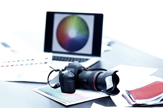 camera,fabric samples and sketches are on the desktop