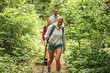© BalanceFormCreative - Group of friends hiking in nature.They walking trough forest and meadows.Blond hair female are in focus.