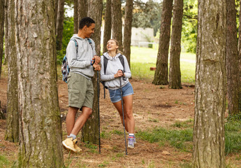 Wall Mural - young couple hiking in nature.they enjoying in nature and fresh air.