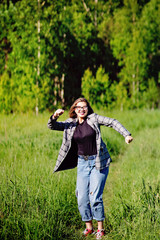 Wall Mural - Young beautiful asian girl having fun and jumping in the forest