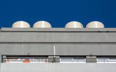 4 water tanks in the roof of a building