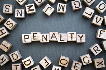 Fototapete - the word penalty wooden cubes with burnt letters, penalty for tax evasion, gray background top view, scattered cubes around random letters