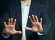 © Natalia - Businessman makes a defensive gesture
