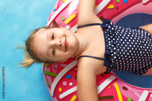 Cute Little Girl In A Bathing Suit Lying On A Donut Inflatable Circle The Child Relaxes On A Blue Background Closeup Portrait Top View Stock Foto Adobe Stock