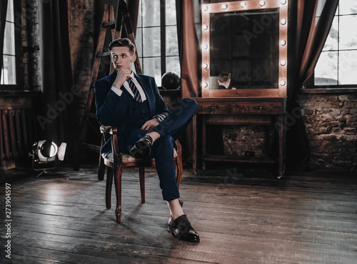 Full suit young handsome businessman sitting in luxury interior Tableau sur Toile