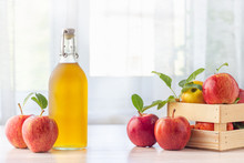 Healthy Organic Food. Apple Cider Vinegar In Glass Bottle And Fresh Red Apples On A Light Background.