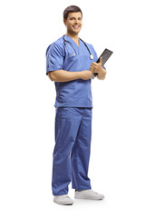 Sticker - Smiling young doctor posing and holding a clipboard