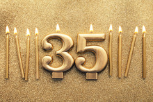 Number 35 Gold Celebration Candle On A Glitter Background