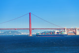 Fototapeta Sypialnia - Cargo ship passing under Golden Gate Bridge, USA