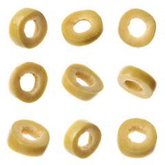 Set of flying cut green olives on white background, closeup