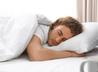 Sticker - Handsome young man sleeping on pillow at home. Bedtime