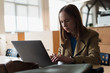 © speed300 - Portrait of attentively woman working on laptop computer in cafe
