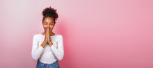 Portrait Of Woman In Supplication Pose With Smile And Close Eyes Over Pink Background. Copyspace