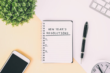 Wall Mural - New Year's Resolutions text on note pad on top of office desk.