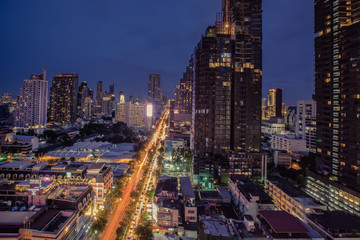 Wall Mural - City scape of building, skyscraper in the Silom/Sathon central business district of Bangkok at night