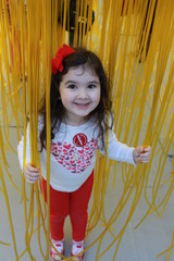 Girl Playing with Yellow Plastic