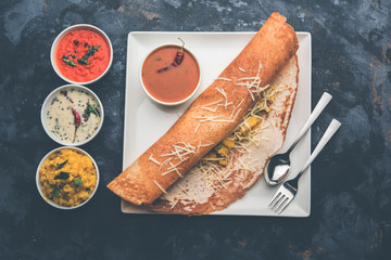 Poster - cheese masala dosa recipe with sambar and chutney, selective focus