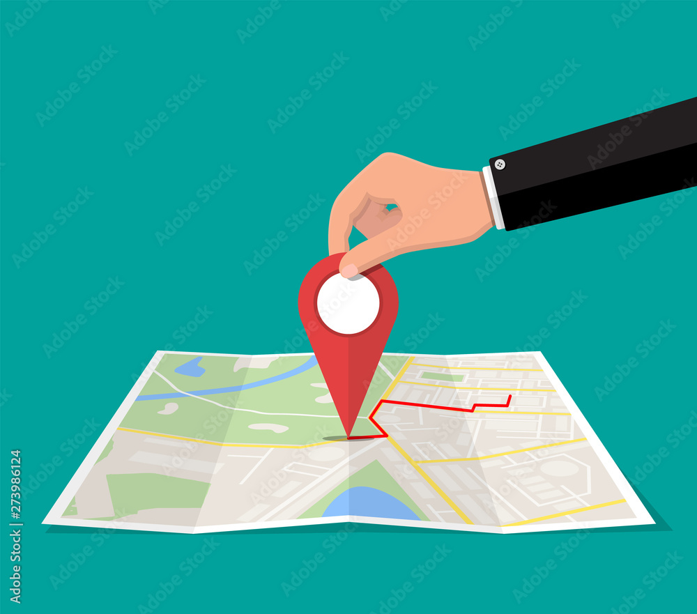 Location pin in hand and paper map. City map with houses, parks ...