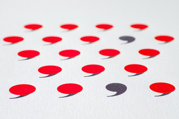 black comma in many red commas.